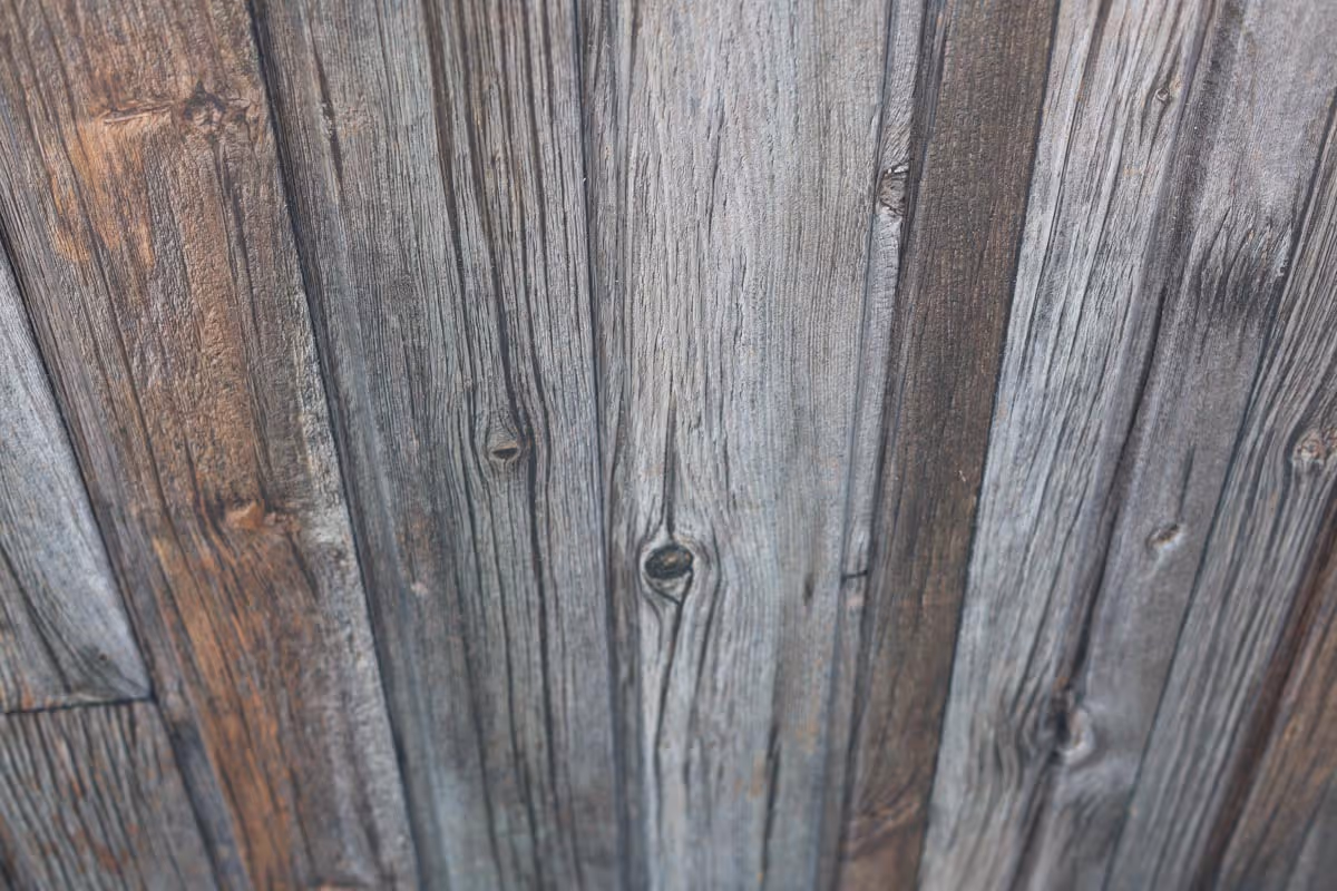 Close-up of weathered wooden planks with visible grain and knots.
