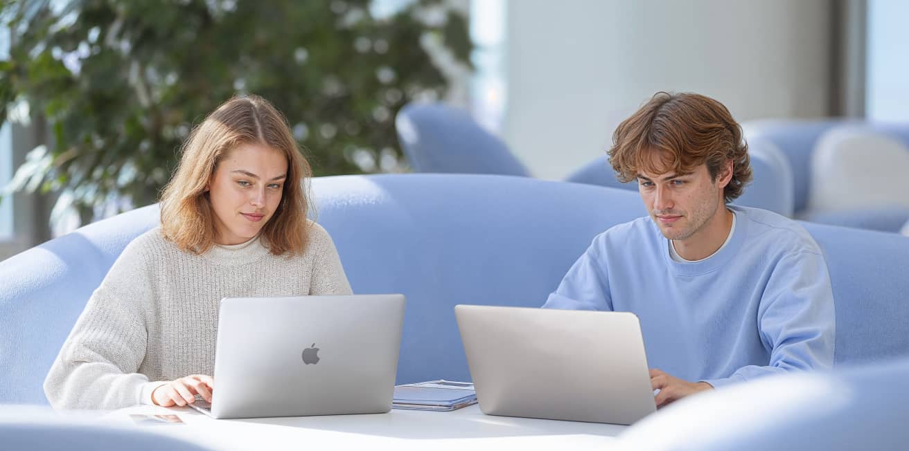 Two People Working On Laptops Defichain Webflow Template | BRIX Template  
