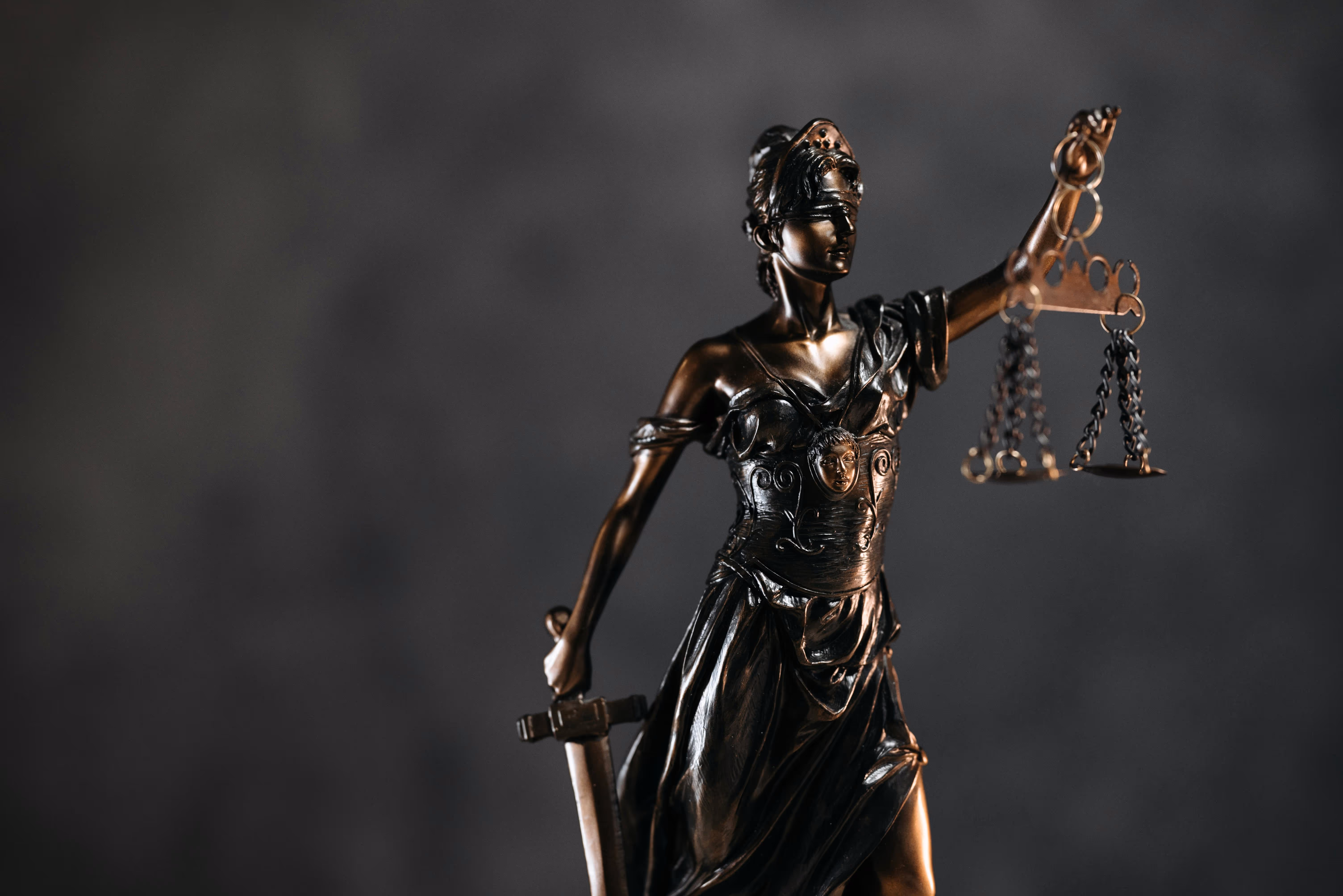 A statue of a judge with the scales of justice.