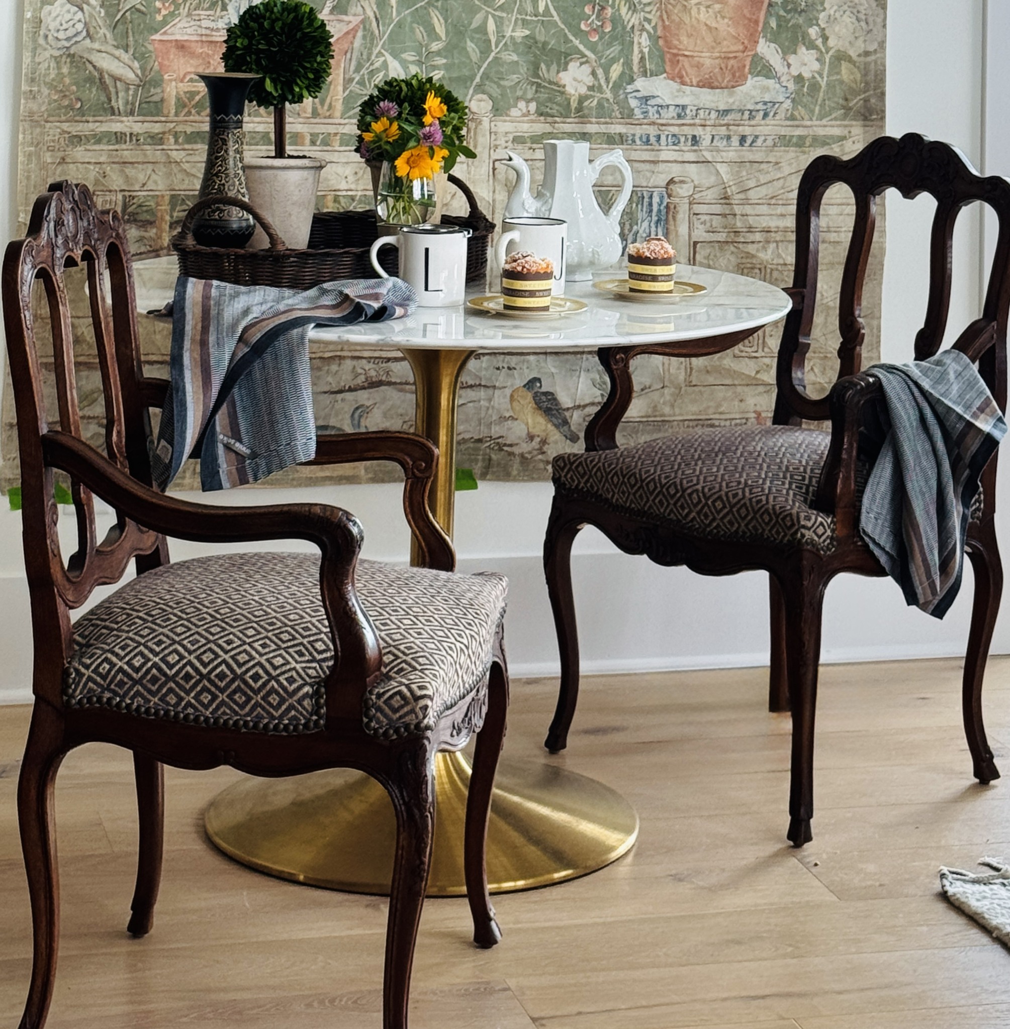 Styled coffee table with elegant seating, layered decor, and warm wood tones.