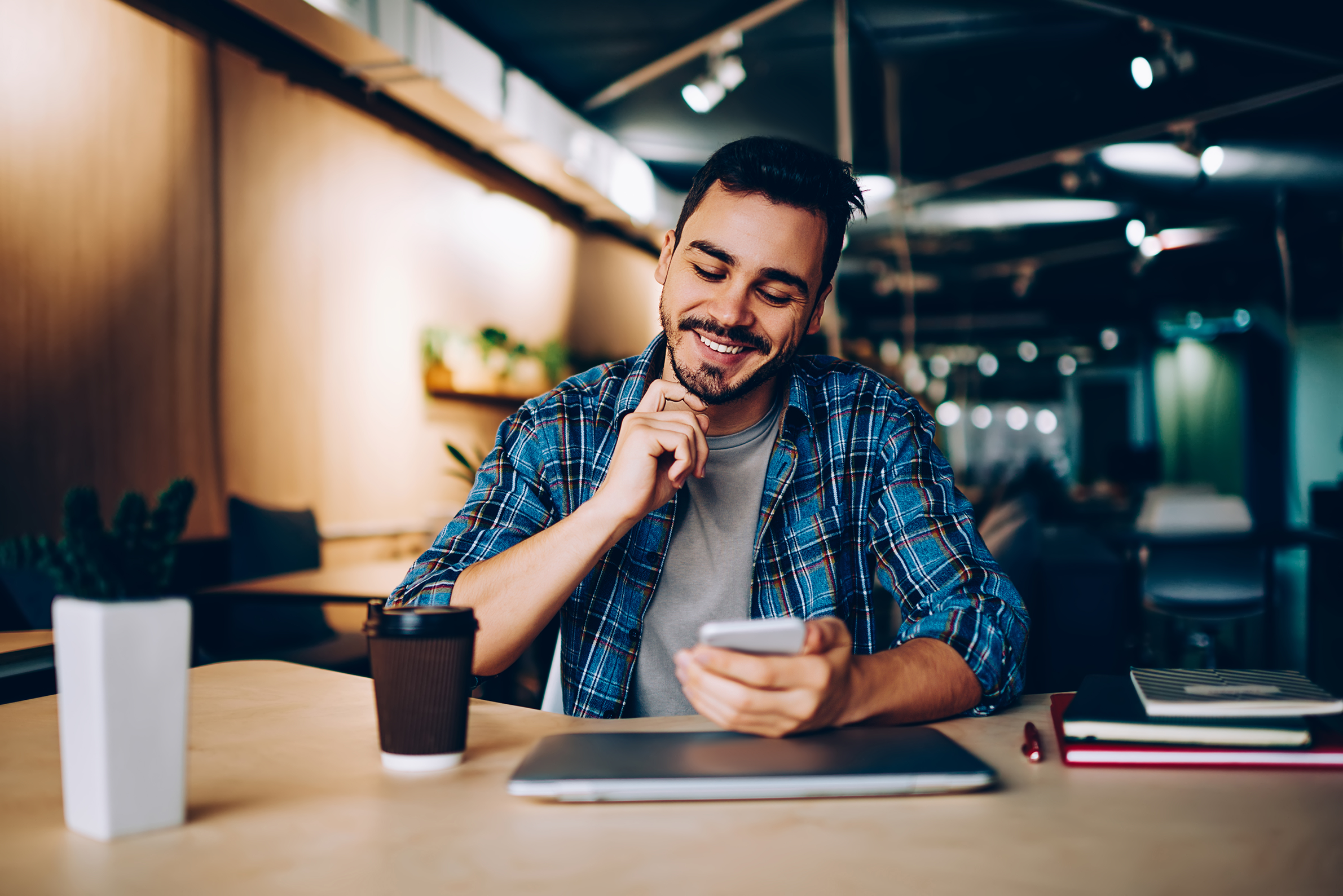 Guy looking at phone happily