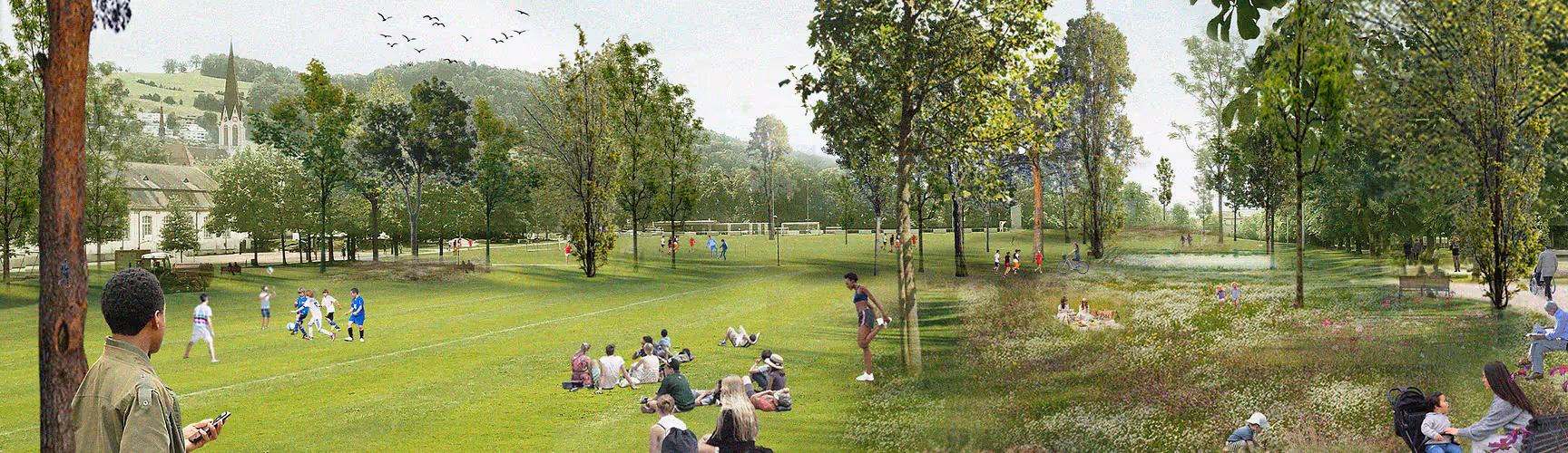 Weitläufige Parkanlage mit Sportplatz, Bäumen und vielen Menschen, die picknicken oder Sport treiben. Im Hintergrund Hügel und eine Kirche.