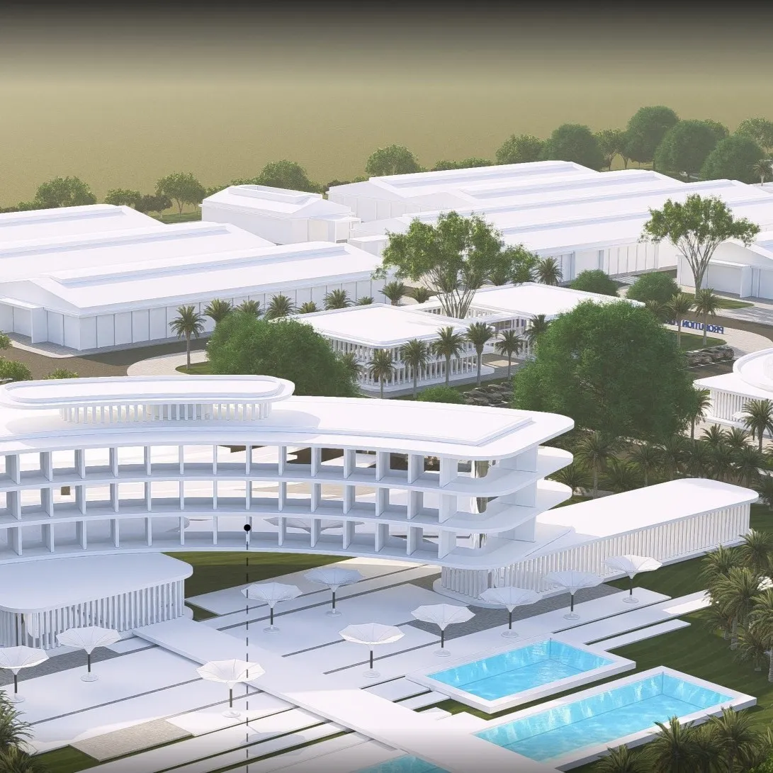 Modern white multi-story building complex with pools, palm trees, and green landscaping.
