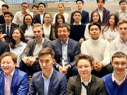 Photo of two founders standing infront of world map on wall