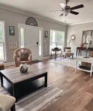 A cozy living room featuring a stylish coffee table, comfortable seating, and natural light.