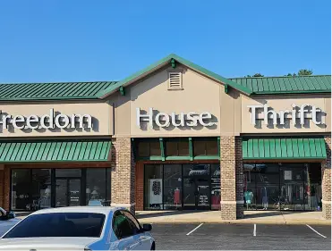 Exterior view of Freedom House Thrift Store with signage.