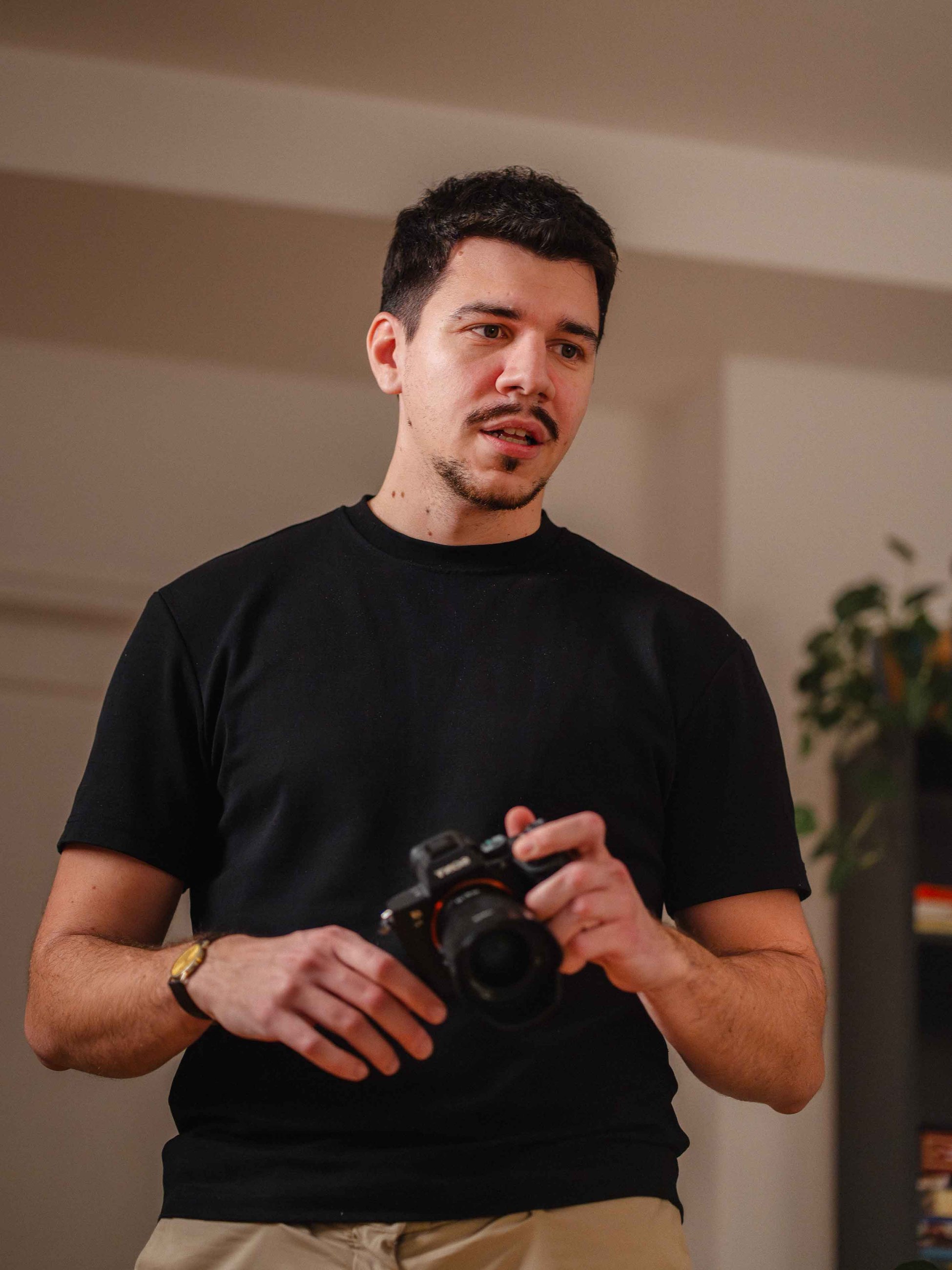 Sven Krakar, founder of Caird Studio, holding a camera