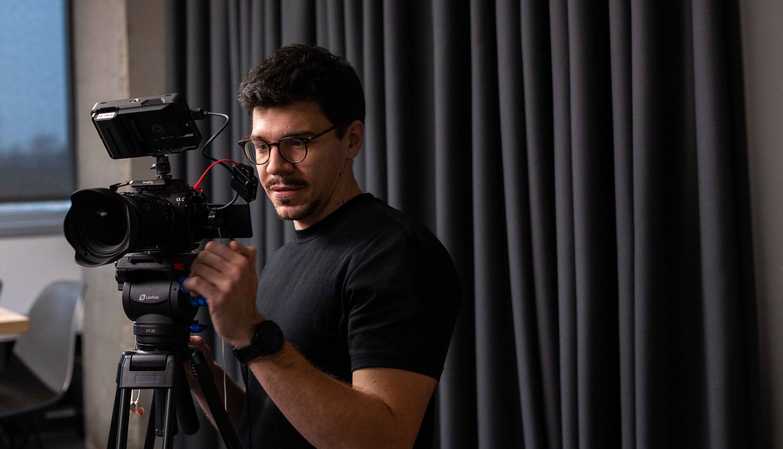 Sven Krakar, founder of Caird Studio, filming with a Sony camera on a tripod