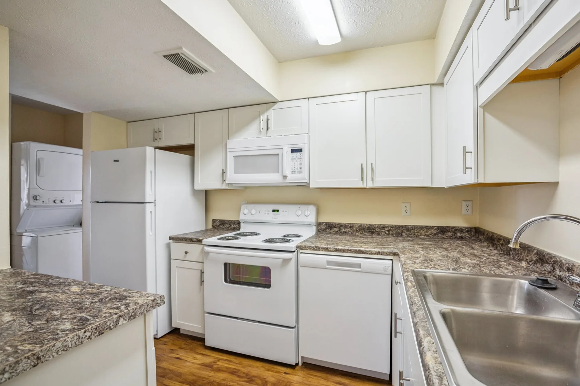 Renovated kitchen with stainless steel appliances and island at Aztec Villa