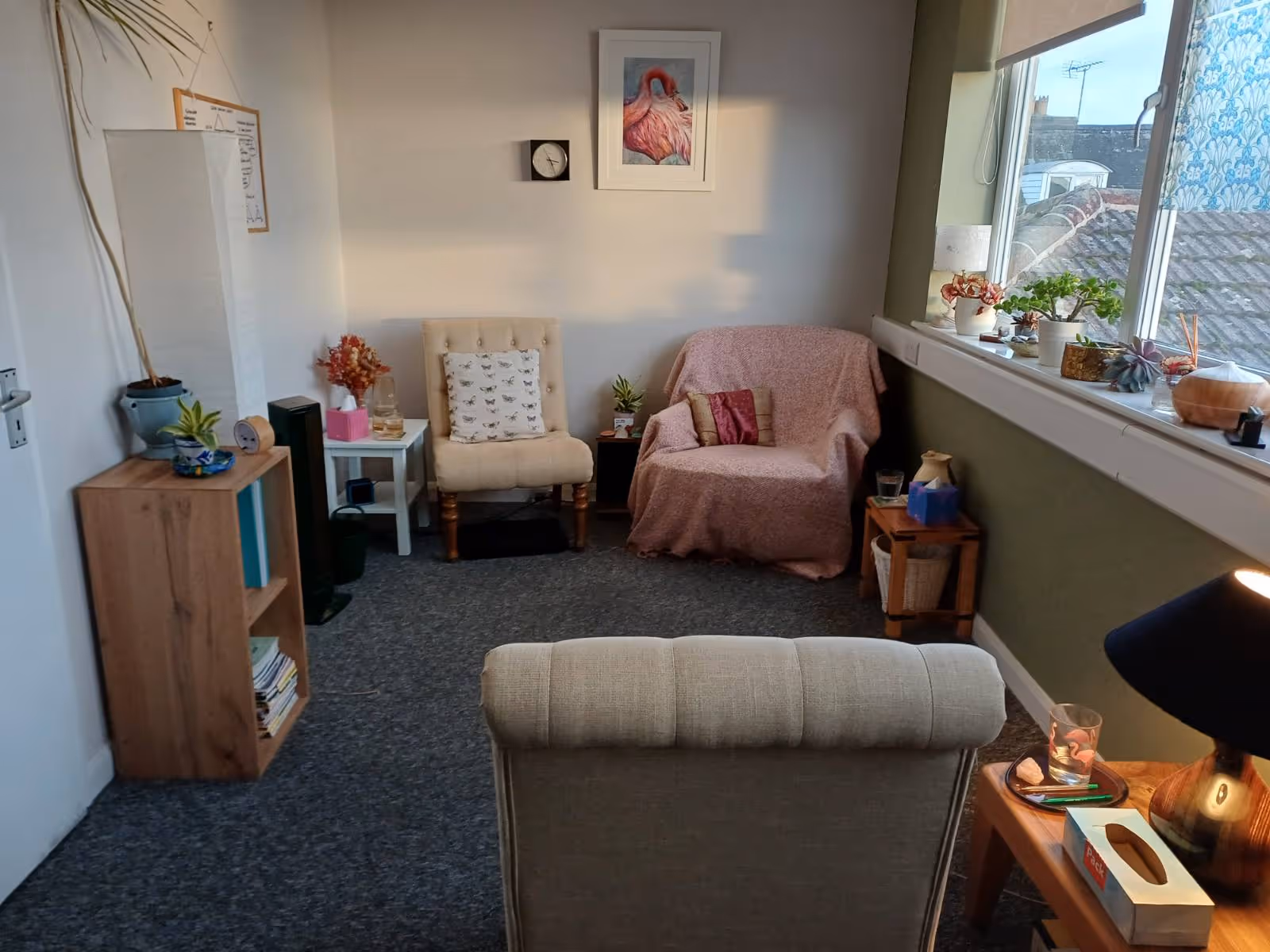 Inviting psychotherapist office near Worthing, Arundel, and Bognor with soft lighting, bookshelves, and a relaxing atmosphere for holistic mental health support.