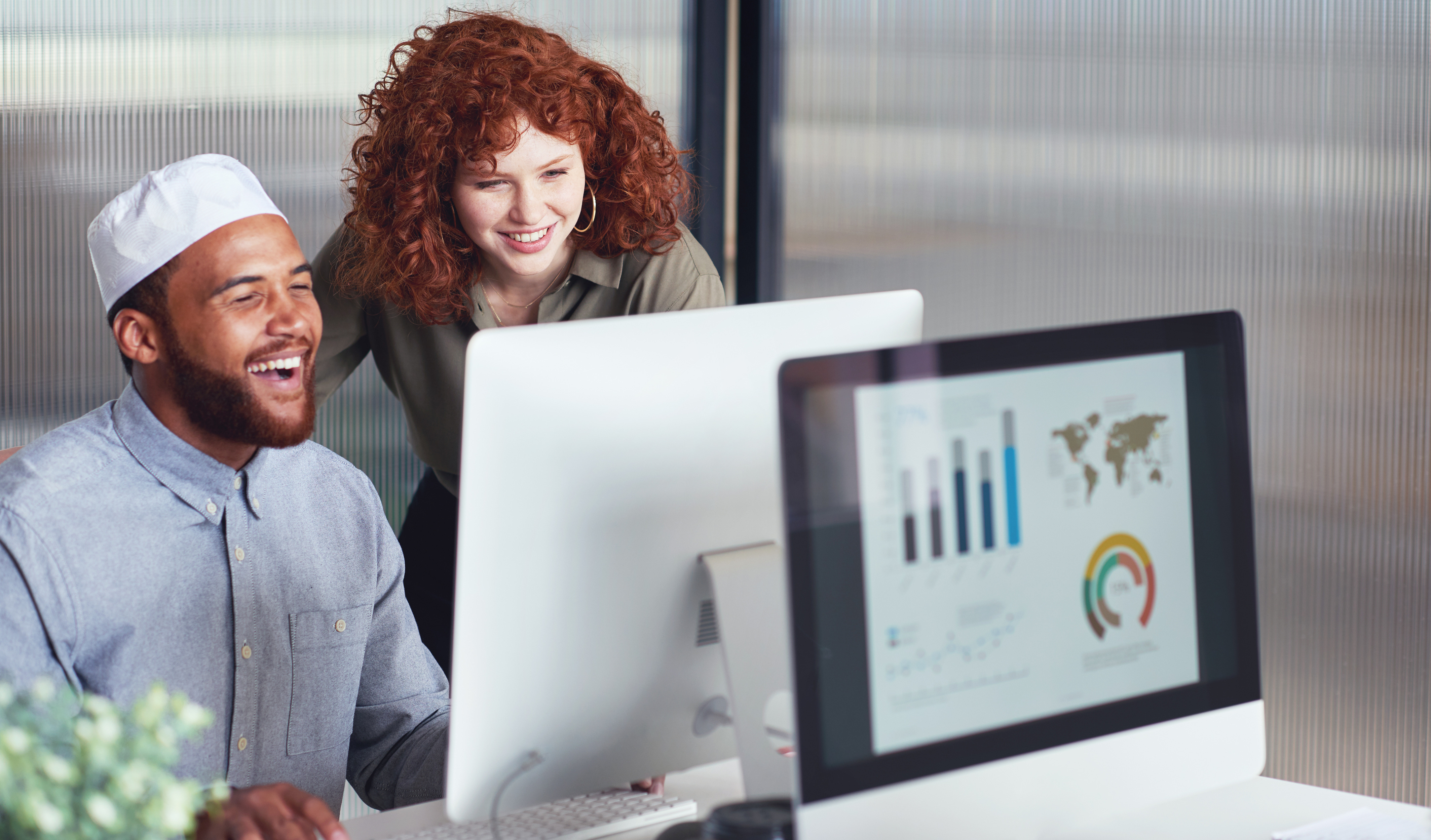 Marketing team reviewing growth analytics on a computer in an office
