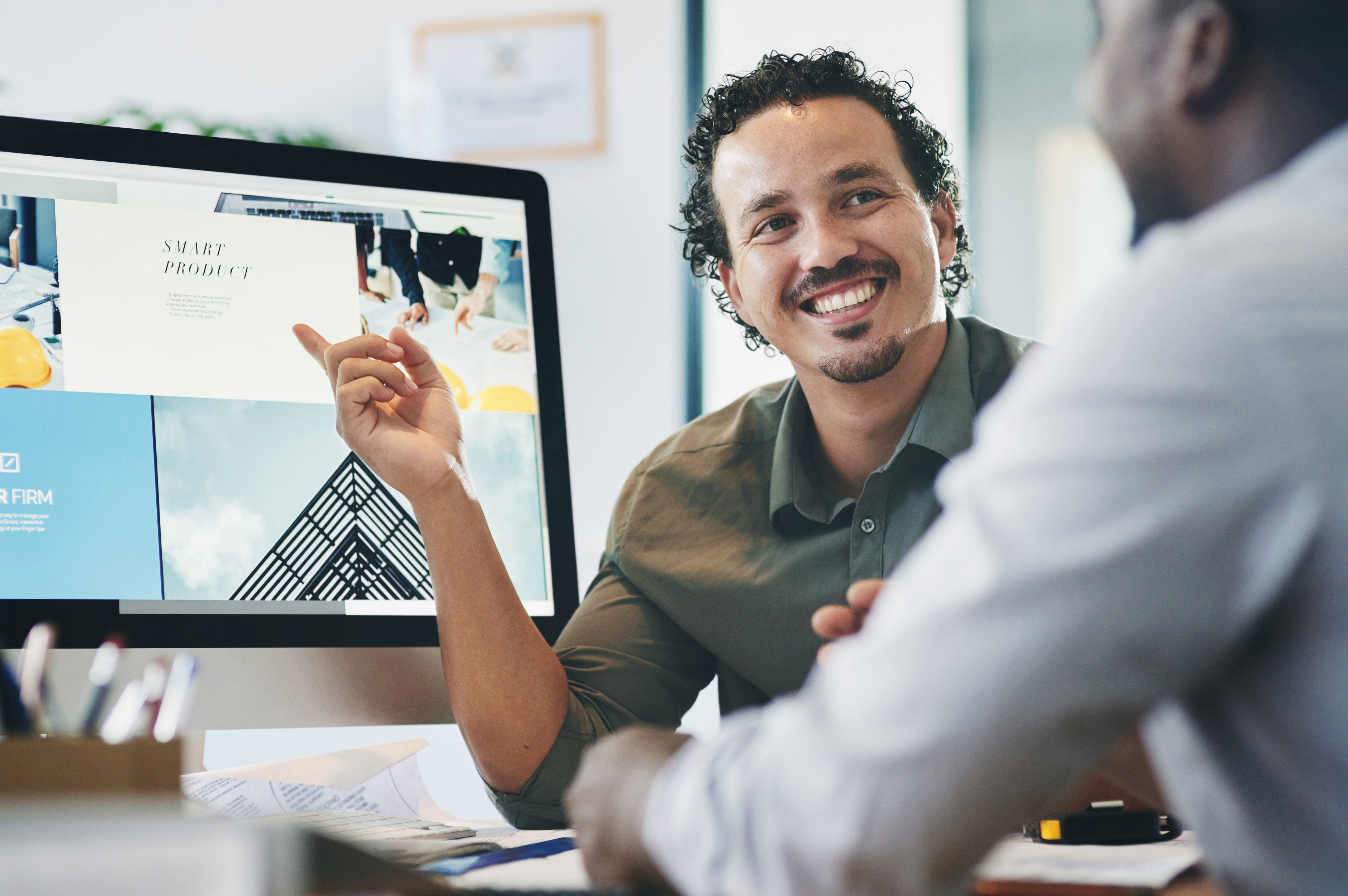 Two professionals discussing a prospecting plan in an office