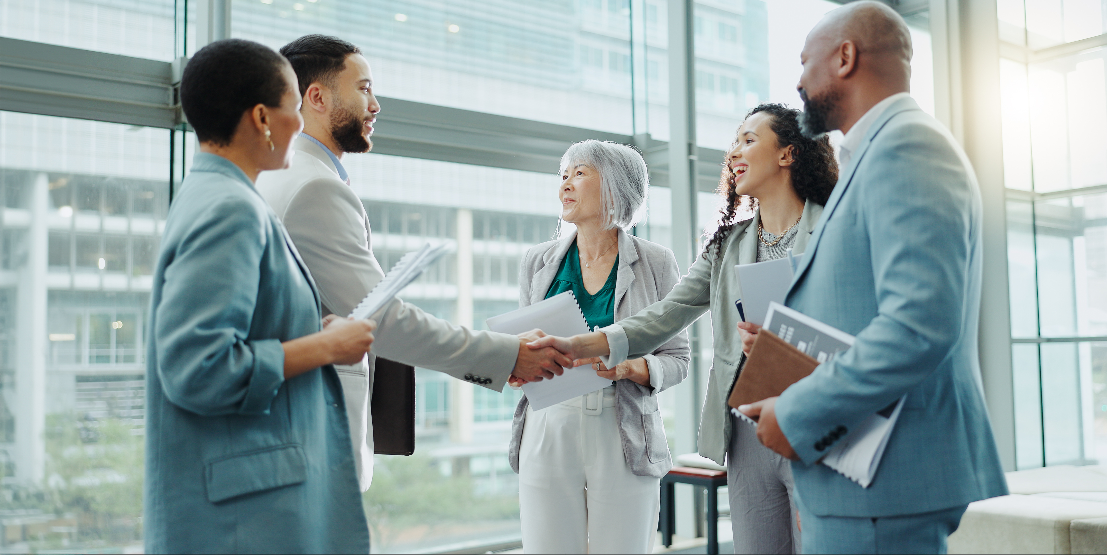 Business people shaking hands after a successful outbound B2B deal