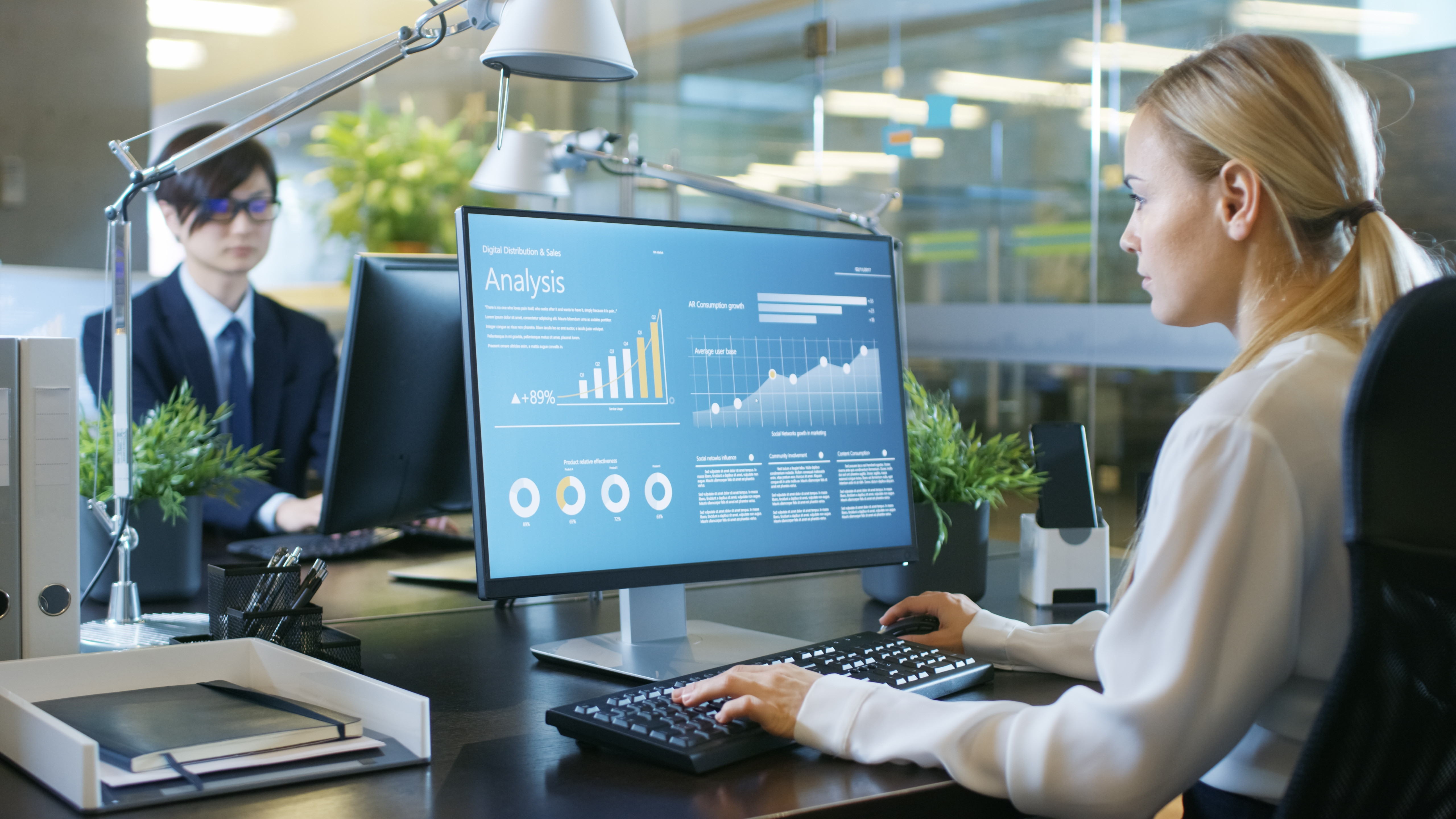 Business colleagues reviewing revenue operations data on a computer