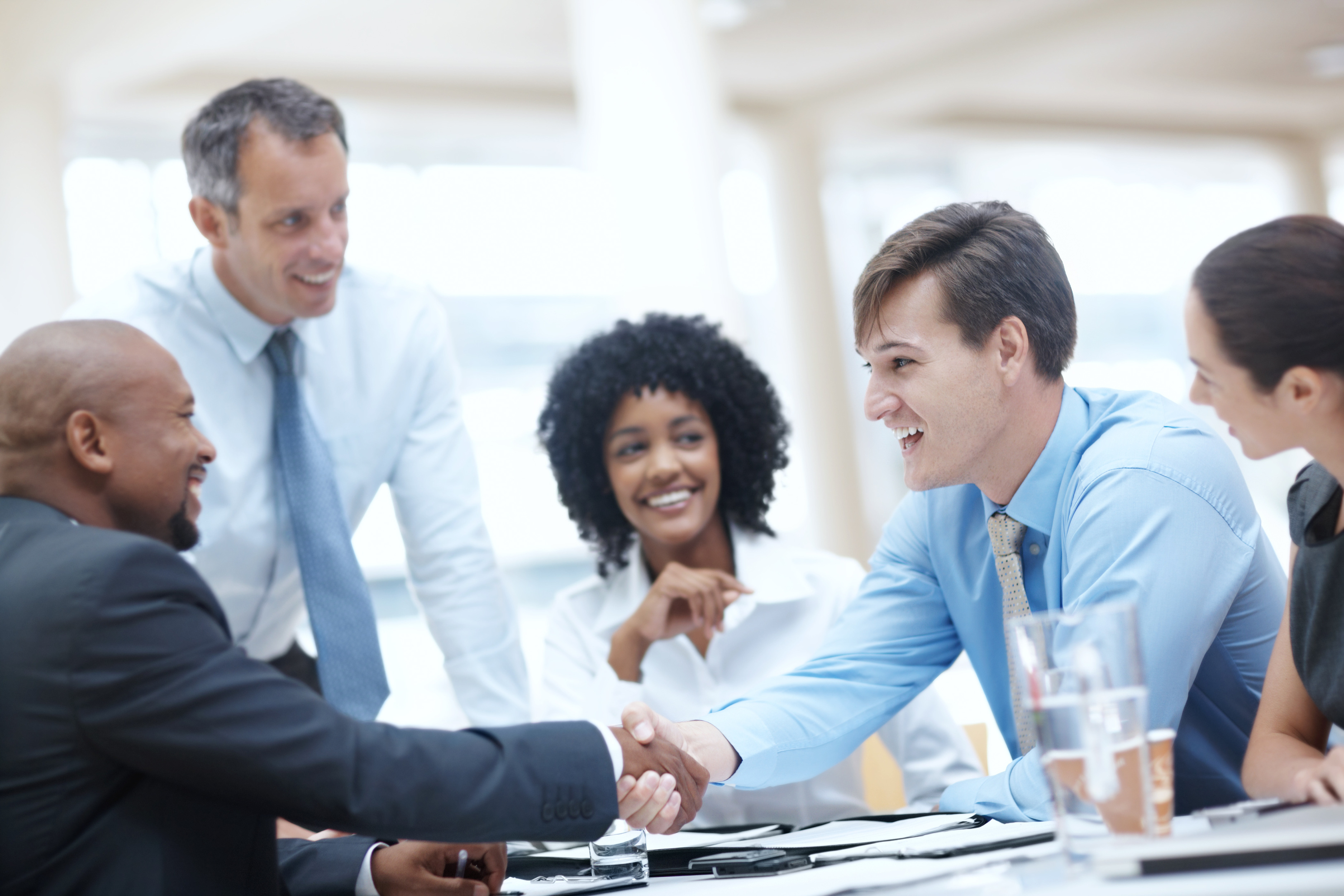 Business team shaking hands on winning new B2B clients in the Americas