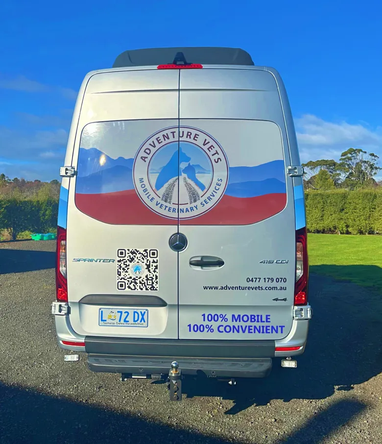 Rear of the Adventure Vets van with the logo, QR code and phone number