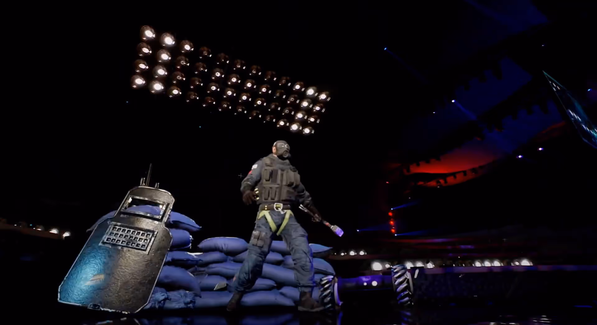 Armed player on sandbags with shield under bright lights at Gamers8 AR opening