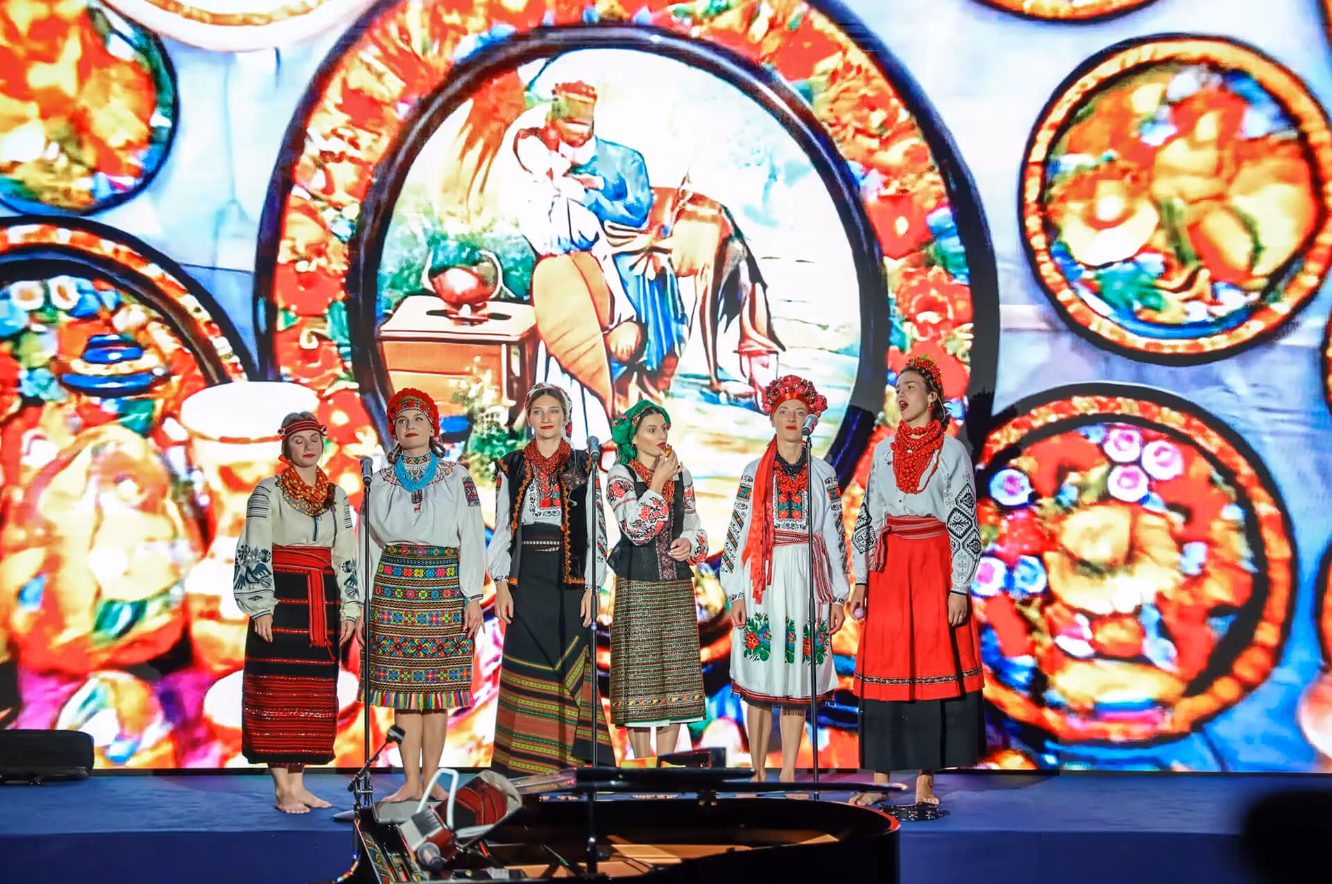 Singers in traditional Ukrainian costumes performing on stage