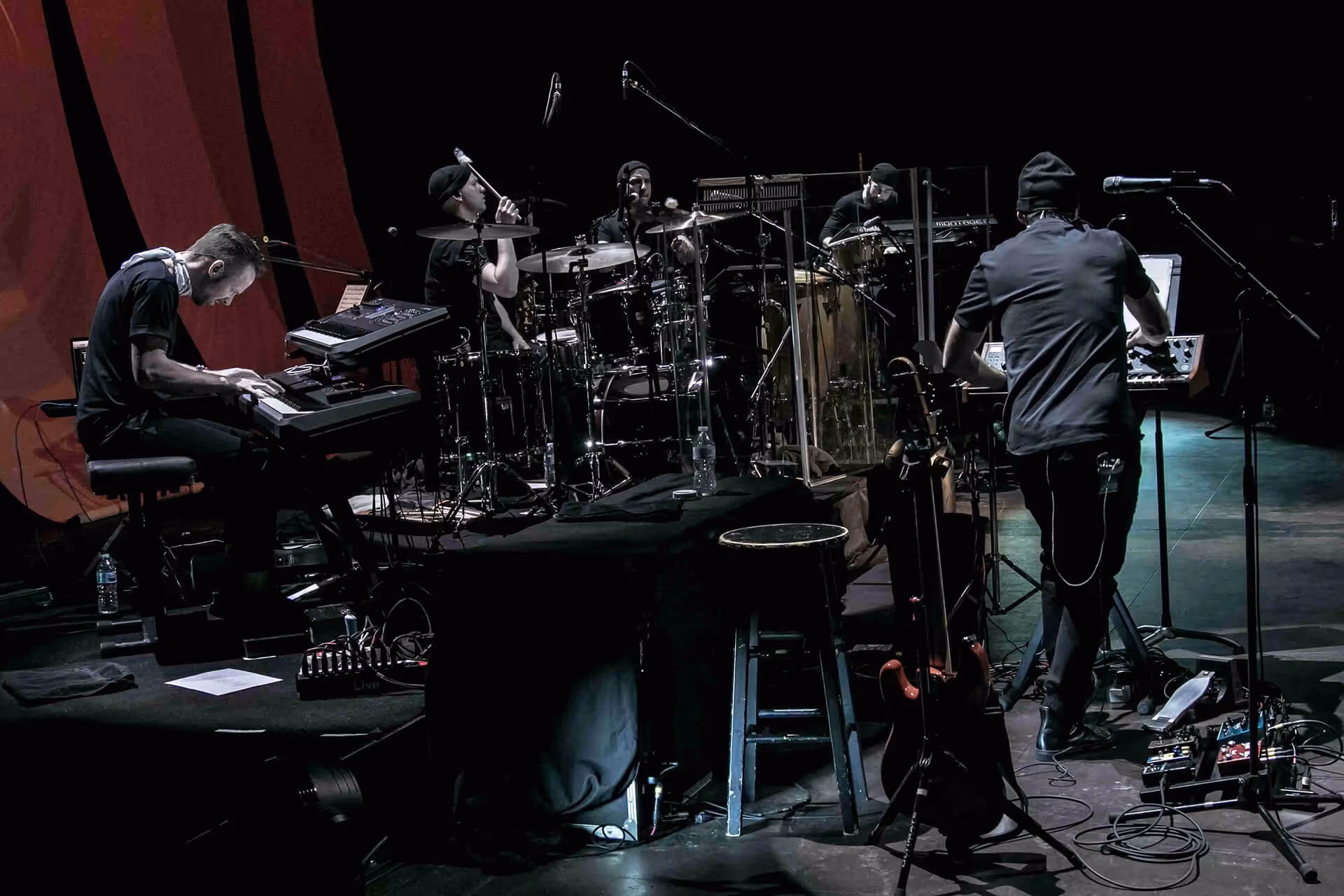 Lara Fabian on stage with support staff behind the scenes