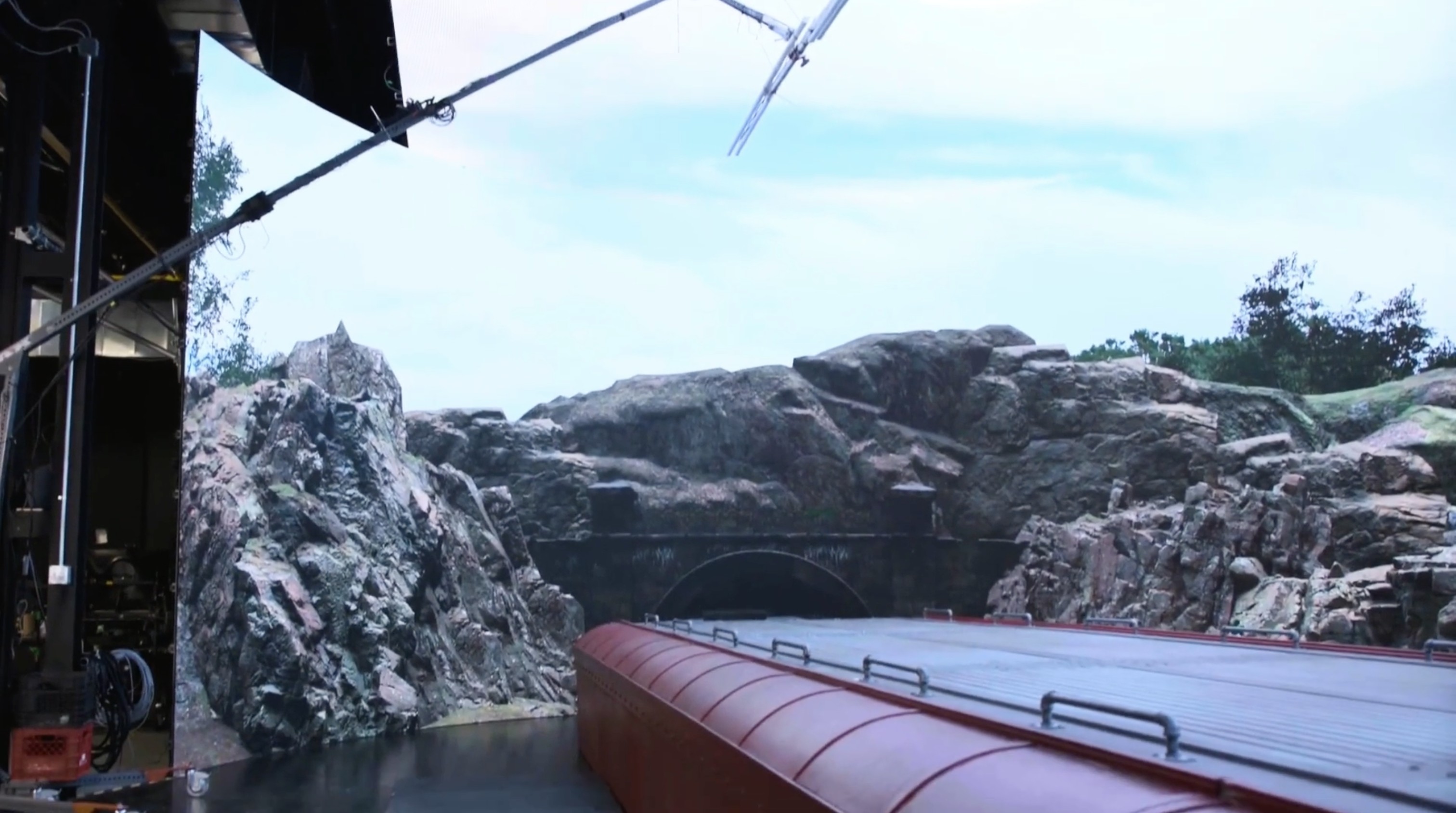 Virtual rock and tunnel environment on the LED wall behind a train roof set