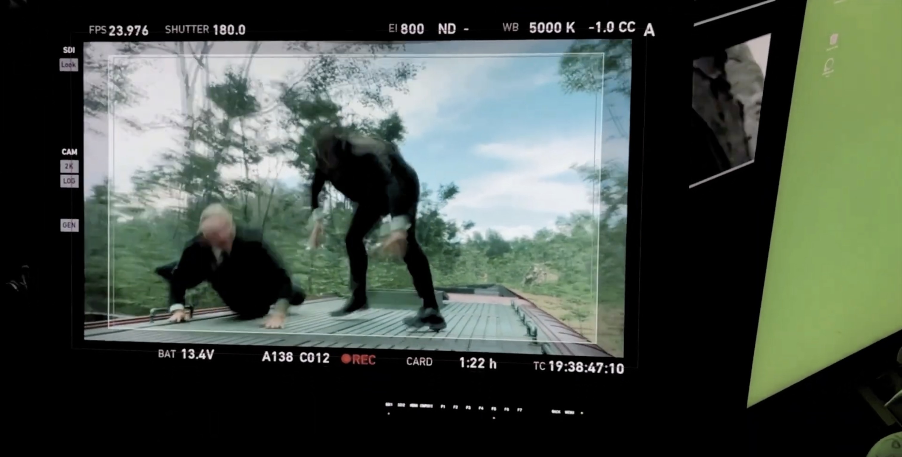 Camera monitor showing a fight on the train roof against the virtual forest