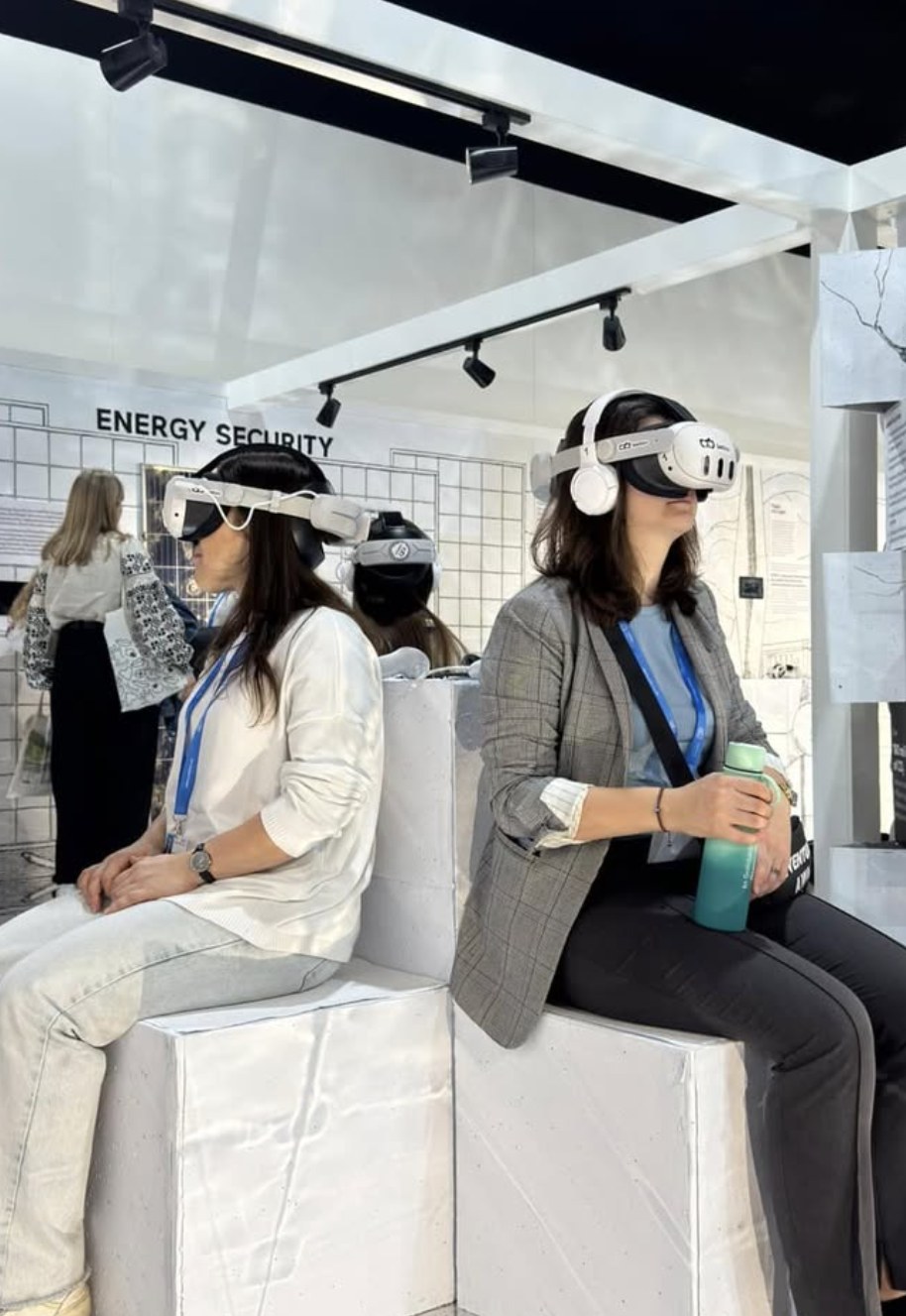 Visitors watching the VR film in headsets at the Ukrainian pavilion, COP29