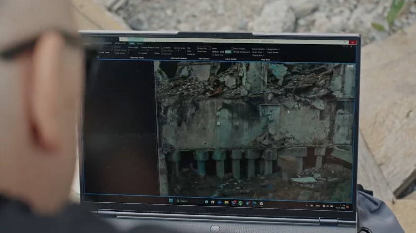 Laptop showing a 3D scan of a destroyed building on site