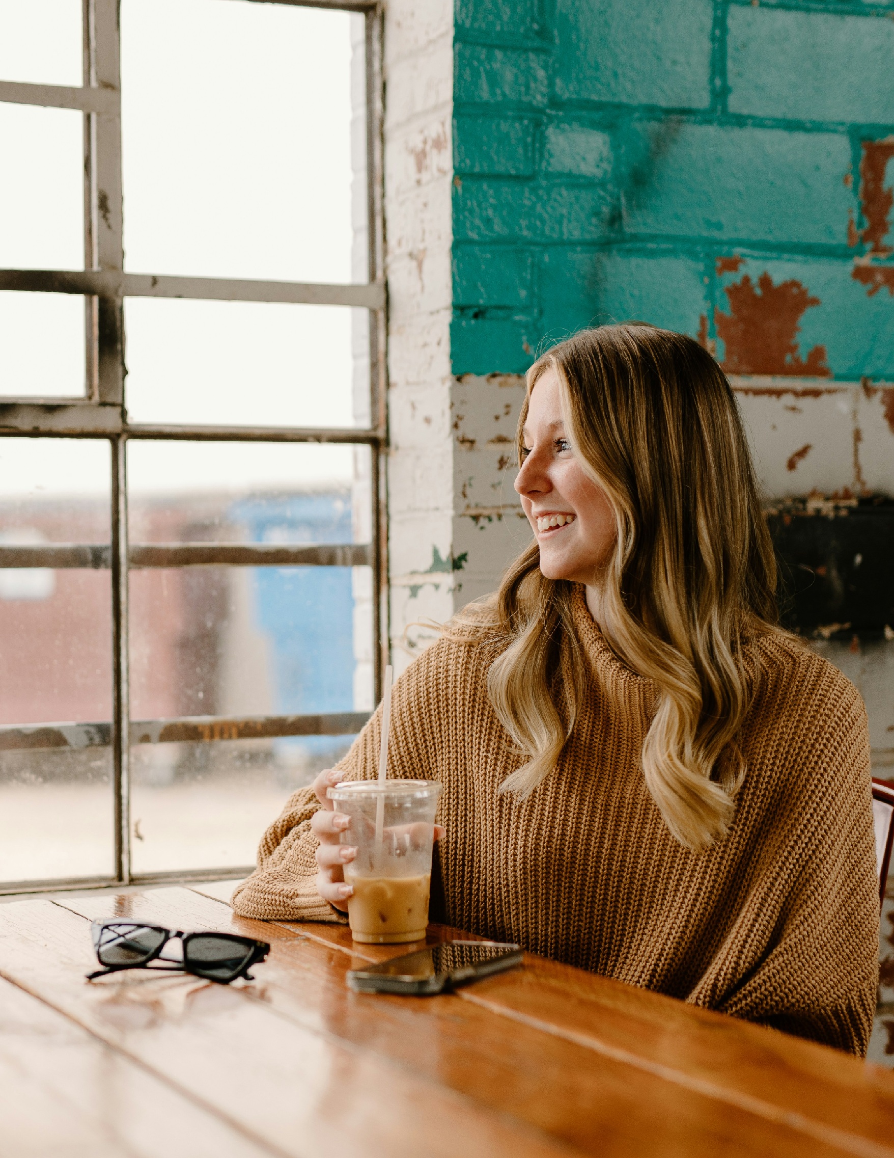 Image of happy woman drinking a coffee at home