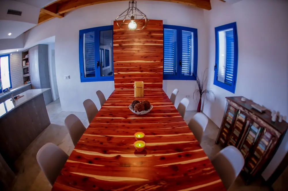 Mesa exclusiva de madera maciza de olivo en el comedor de la casa en Formentera