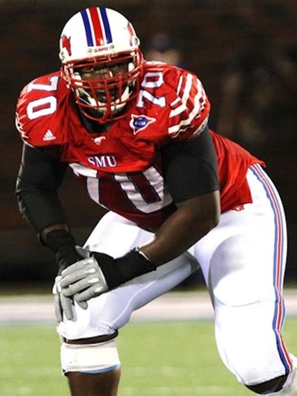 Kelvin as a SMU football player wearing number 70 in red jersey and white pants in a ready stance on the field.