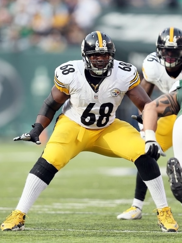 Kelvin as a Pittsburgh Steelers football player number 68 in a defensive stance on the field during a game.