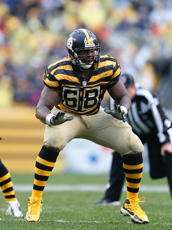 Kelvin as a Pittsburgh Steelers football player wearing number 68 in a defensive stance on the field during a game.