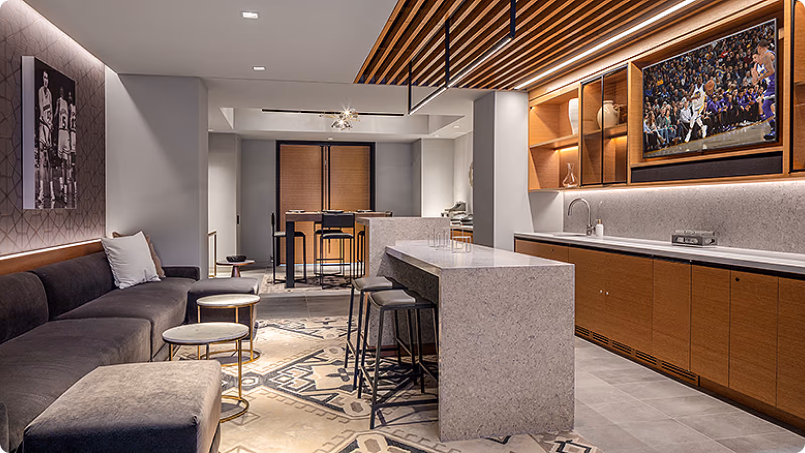Modern luxury suite with basketball artwork, kitchen, and lounge area