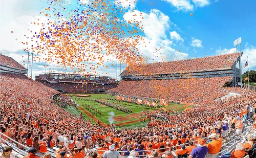 Packed stadium with orange and purple balloons during Clemson football game