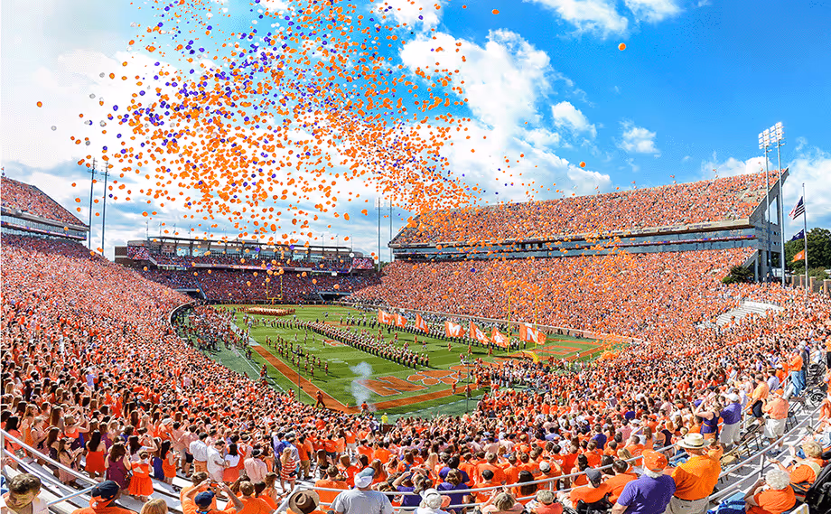 Packed stadium with orange and purple balloons during Clemson football game