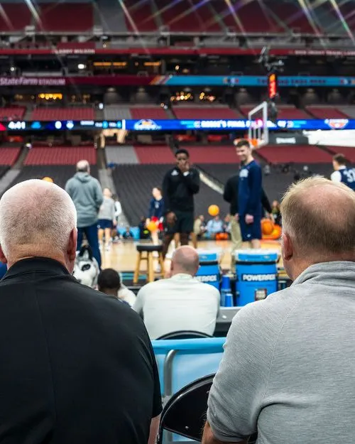 Spectators watching basketball event from behind at State Farm Stadium