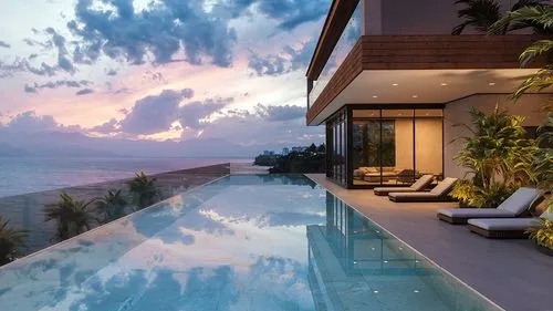 Luxurious infinity pool overlooking ocean and mountains at sunset