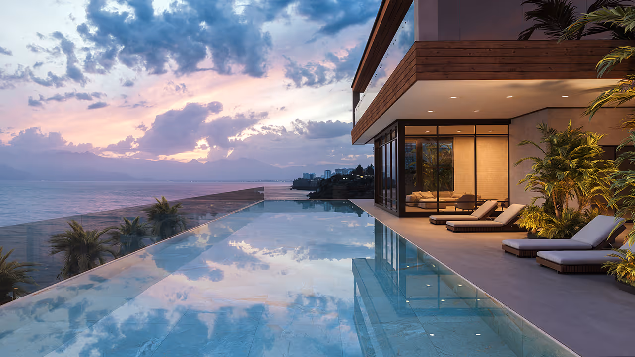 Luxurious infinity pool overlooking ocean and mountains at sunset