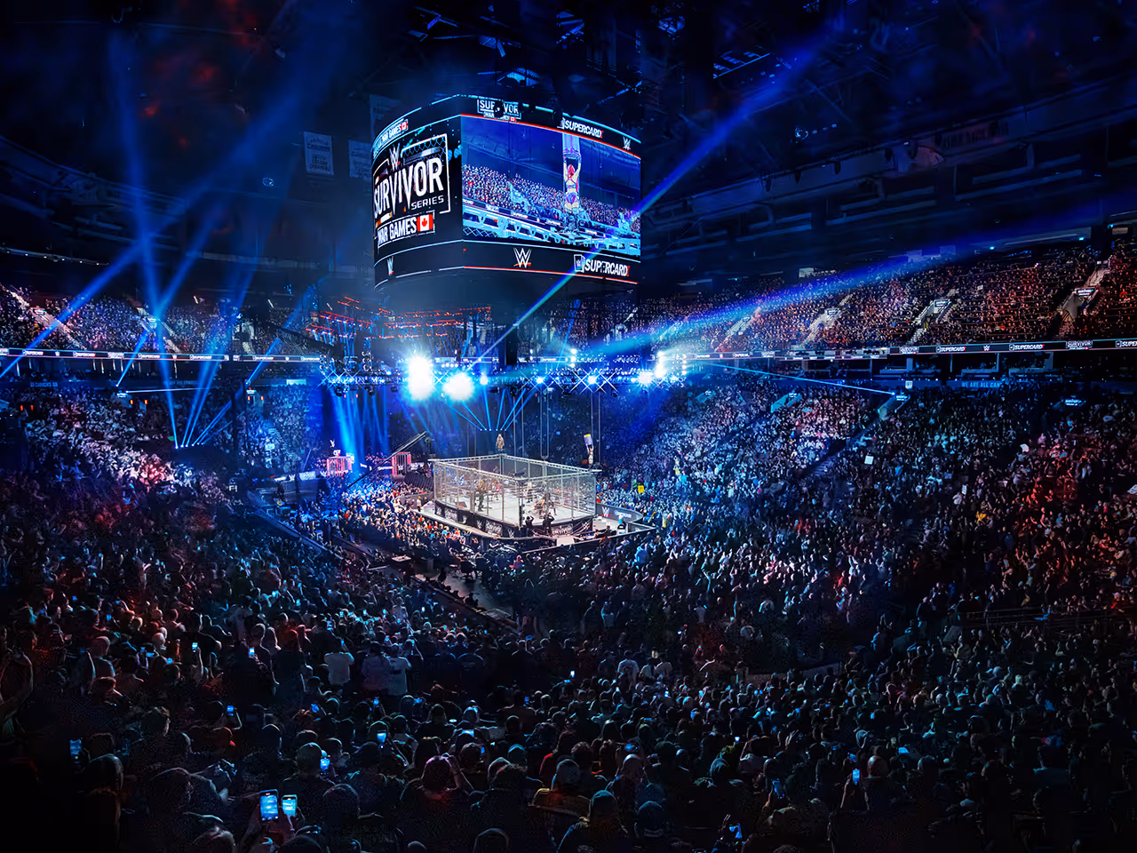 WWE Survivor Series event with packed arena and steel cage wrestling ring