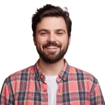 Smiling man with short dark hair and beard wearing a red plaid shirt over a white t-shirt.