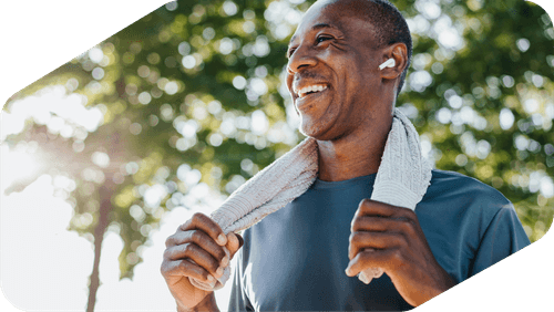 A man smiling and looking healthy and active as he ages.