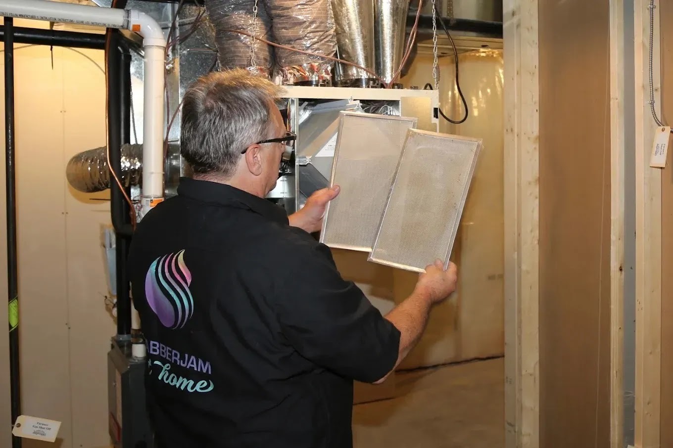 Technician performing HVAC maintenance in a cozy Edmonton home, highlighting the importance of annual tune-ups