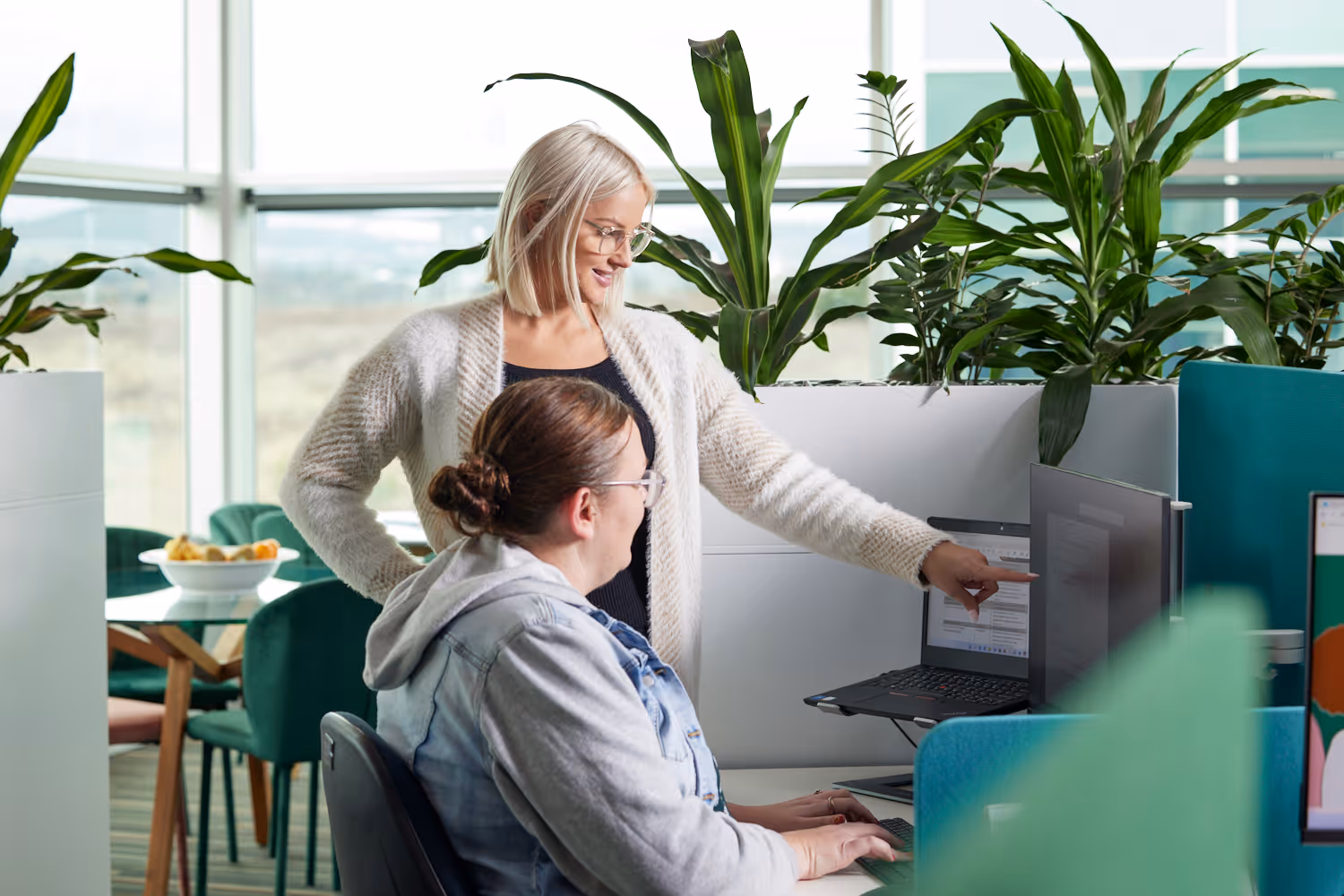 2 Parbery staff members at a desk. One pointing at the computer screen.
