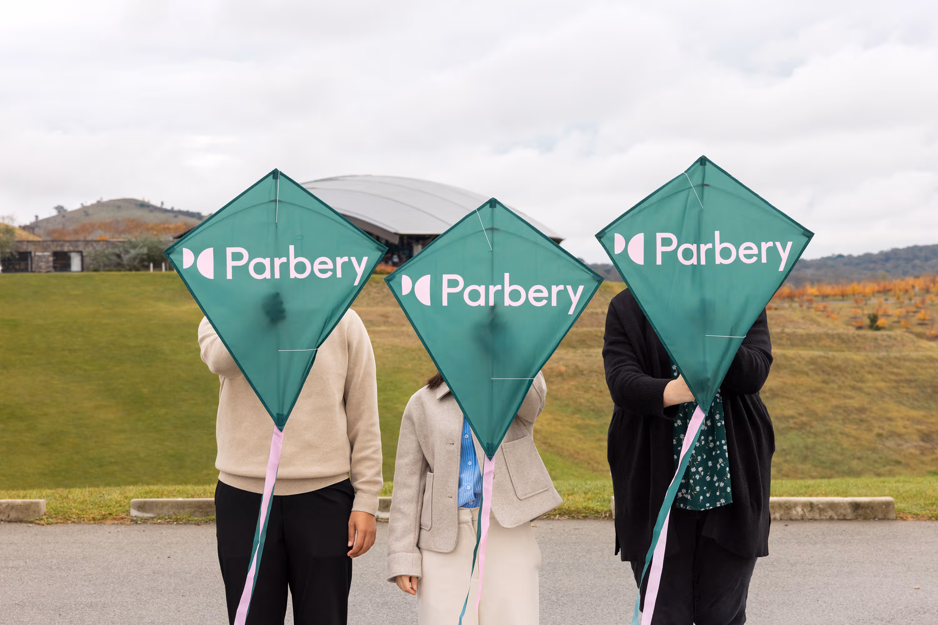 3 Parbery staff members holding branded kites