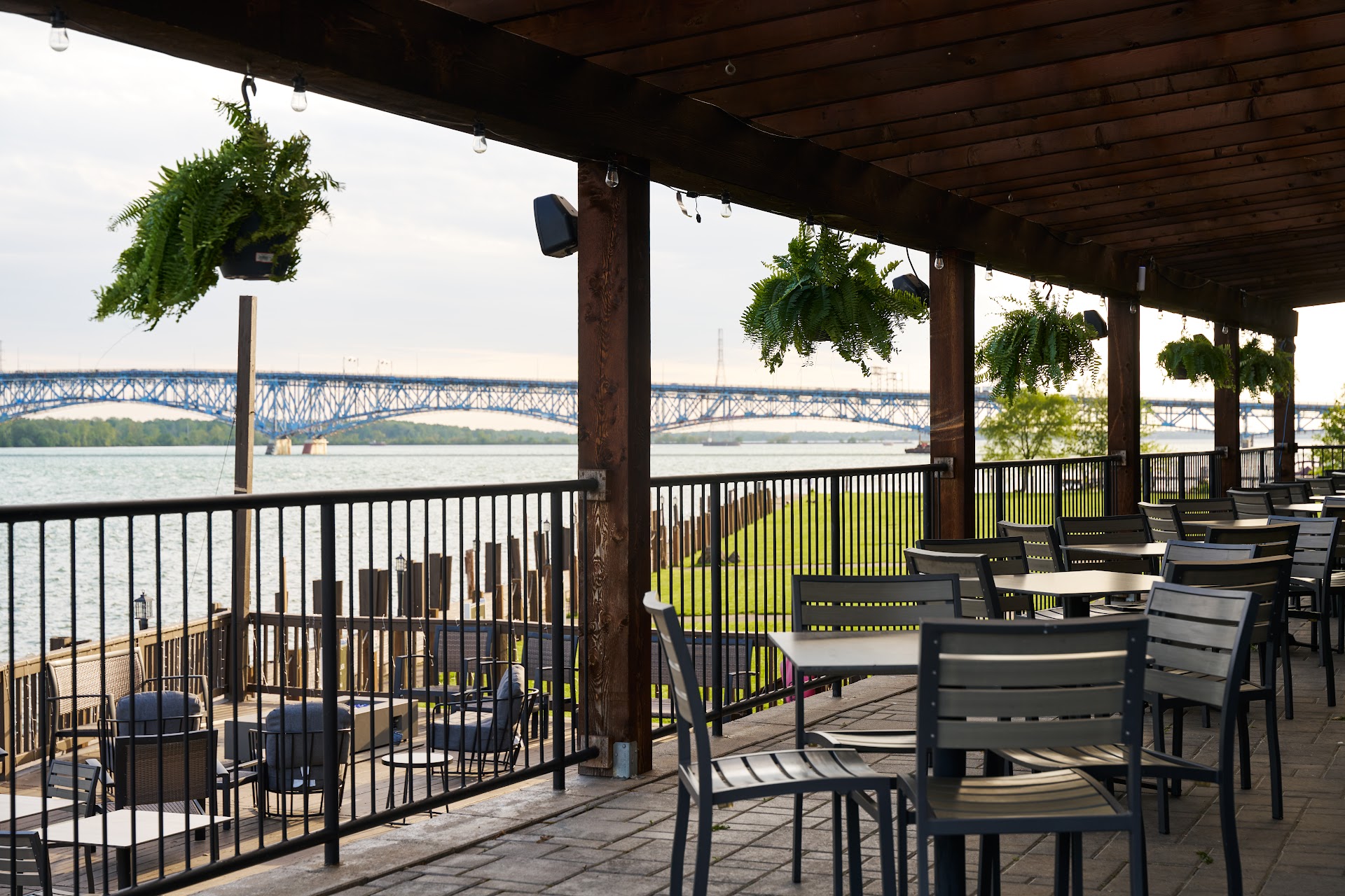 Bella Vista's waterfront patio under the pergola with tables overlooking the water