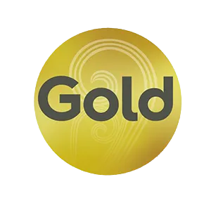 
A logo featuring the word "Gold" in a dark gray, sans-serif font. The text is placed over a circular, golden background. The background has faint, swirling or spiral-like patterns visible within the gold color