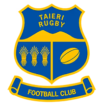 A logo for a sports club. It's a shield-shaped crest, with a yellow border and a blue background. At the top of the shield, the text "TAIERI RUGBY" is written in yellow. The main part of the shield is divided into three sections. The left section contains three bundles of wheat, and the right section contains a rugby ball. Both the wheat and rugby ball are yellow. Below the shield, a banner with a yellow border and a blue background reads "FOOTBALL CLUB" in yellow letters.
