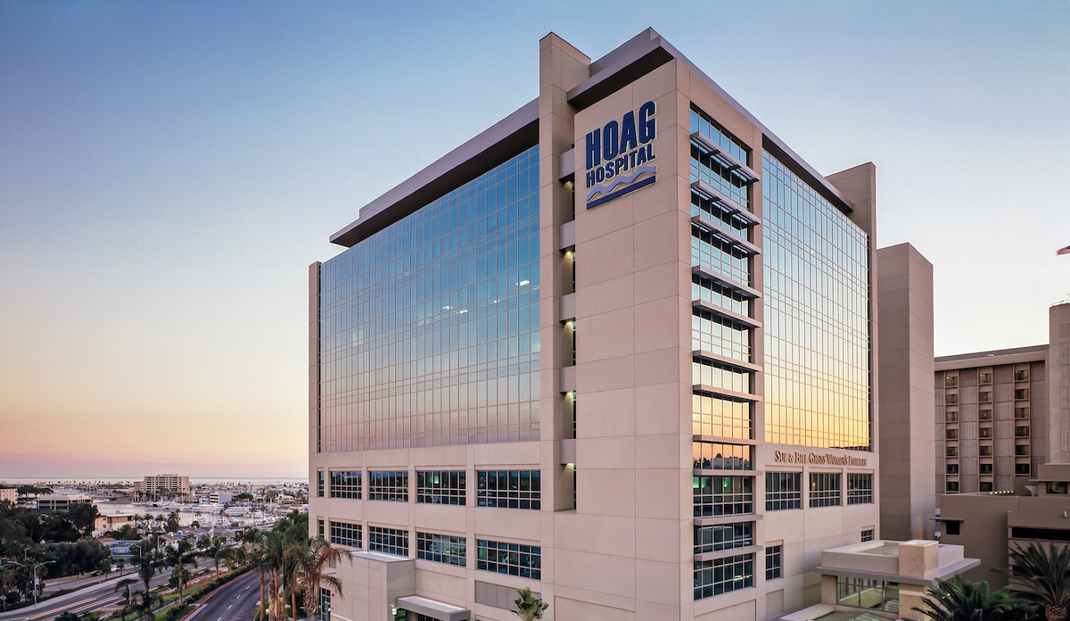 Exterior view of Hoag Hospital in California at sunset, showing modern glass façade and high-rise architecture.