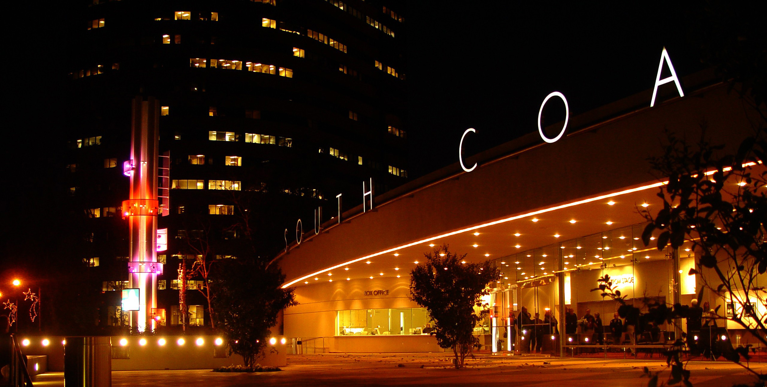 South Coast Theatre building with lights at night