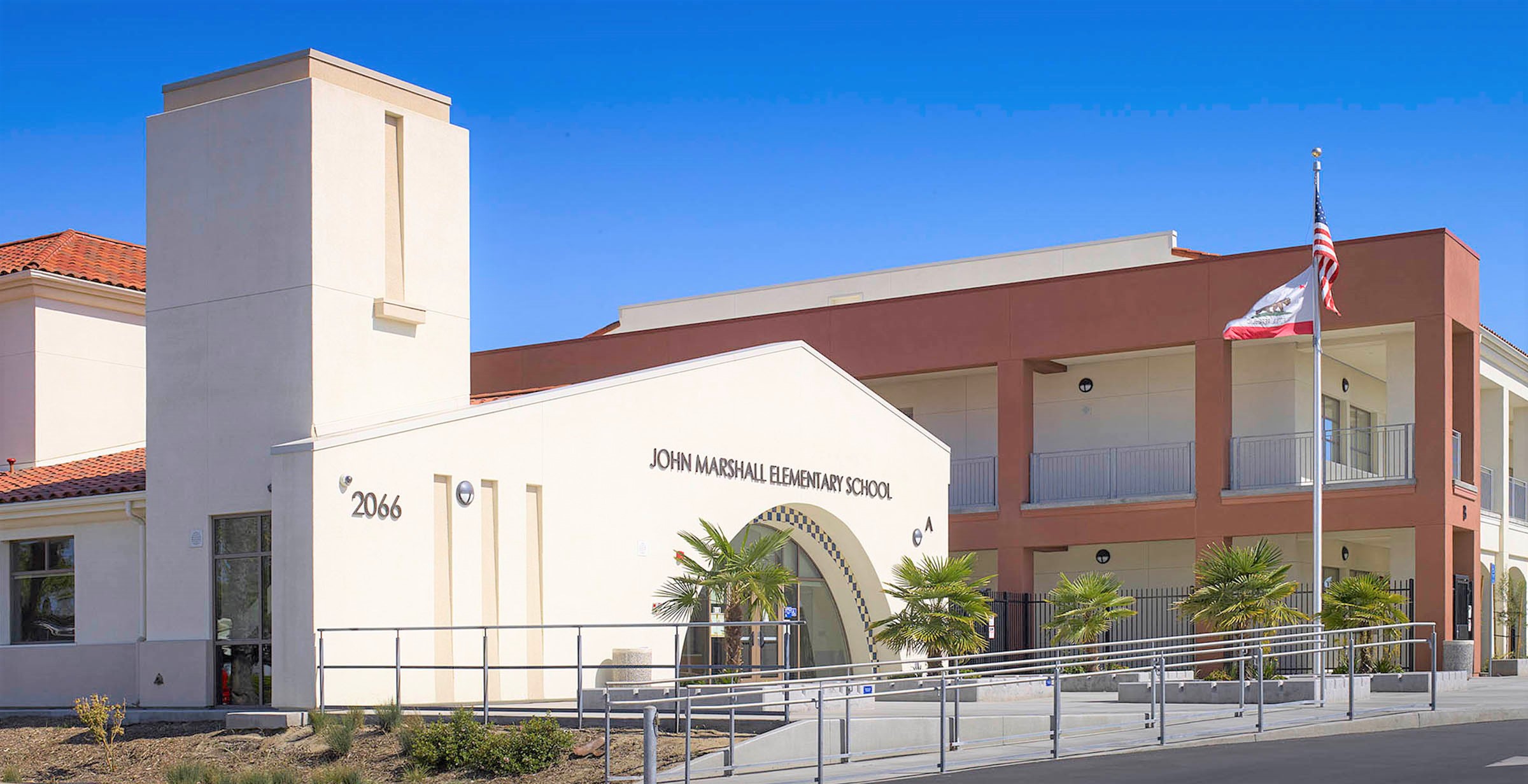 Exterior view of Hoag Hospital in California at sunset, showing modern glass façade and high-rise architecture.